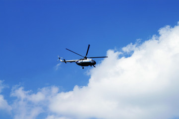 Fototapeta na wymiar civil helicopter in cloudy skies