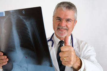 doctor giving thumbs up after examining x-ray