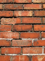 close up of an old weathered red brick wall.