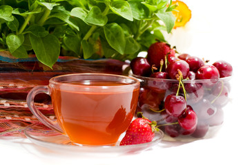 cup of tea with fruit on a background of flower