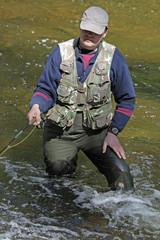 Naklejka premium fisher in river
