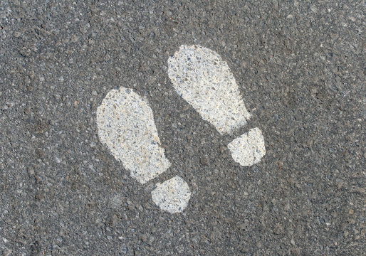 painted footprints on asphalt