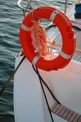 orange lifebuoy hanging on the back of the boat
