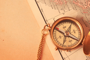 antique brass compass over old map