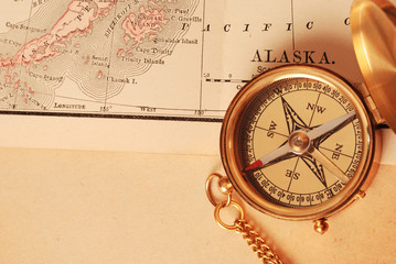 antique brass compass over old map