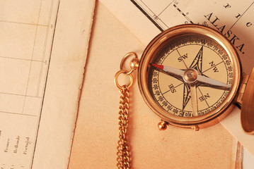 antique brass compass over old map
