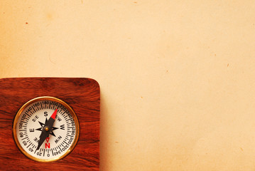 antique wooden compass over old background