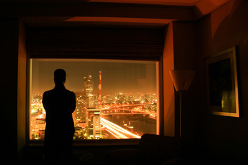 Silhouette of man at window