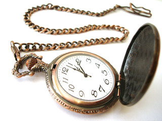 close-up of old golden clock on white background