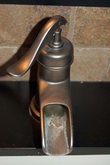 vertical closeup of tap faucet