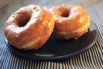 two glazed doughnuts