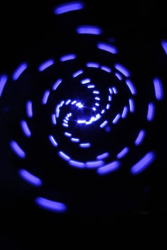 blue spiral abstract against black background.