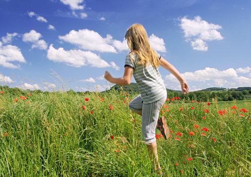 moving girl on poppies field
