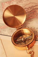 antique brass compass over old map