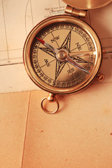 Fototapeta na wymiar antique brass compass over old map