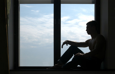 silhouetted man on the windowsill
