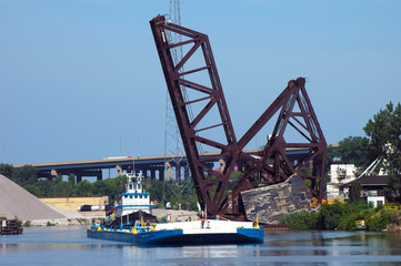 tug  under railroad bridge
