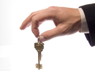 Hand with keys on a white background.