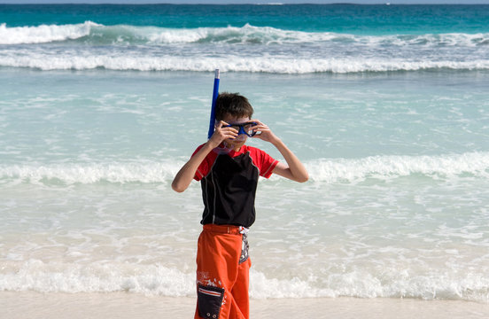 boy with snorkel mask at beach