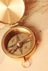 antique brass compass over old map