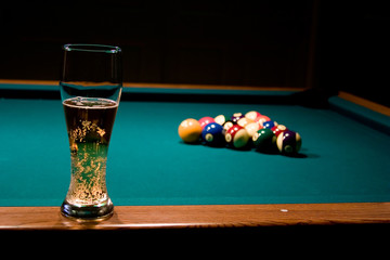 glass of beer on the pool table