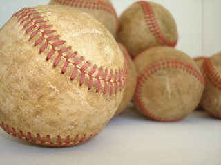 a bunch of old baseballs – three of four in series