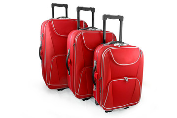 Three red travel suitcases (trolley) - isolated