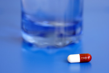 capsule and glass of water