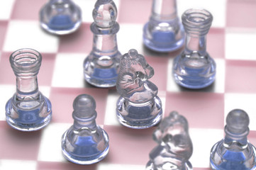 various chess figures on the glass chessboard