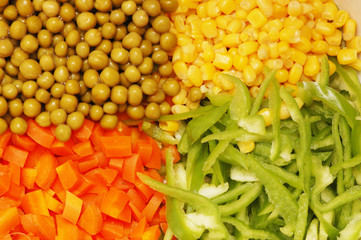 close up of salad with corn, carrots, peppers and peas