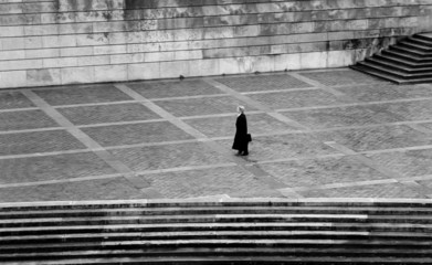 woman walks across square