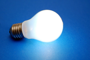 lit bulb on blue background