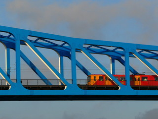 subway train on blue bridge