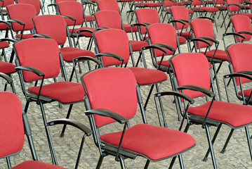 empty red chairs in auditorium