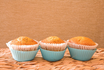 three muffins in blue cups