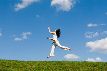 Fototapeta na wymiar jumping girl in meadow