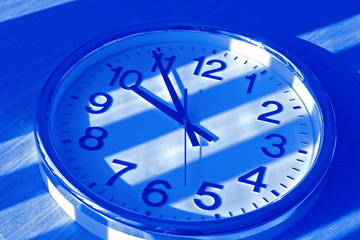 Fototapeta na wymiar clock in blue shadow
