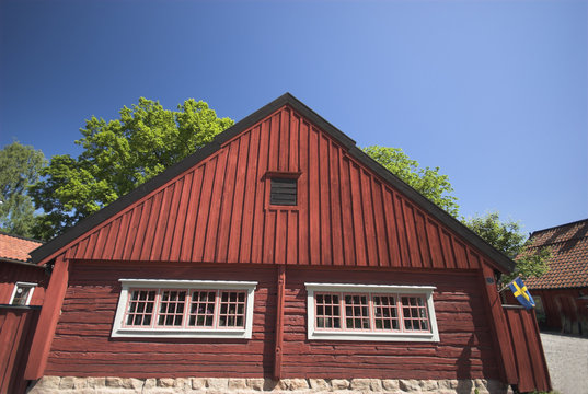 red swedish wooden house sky blue