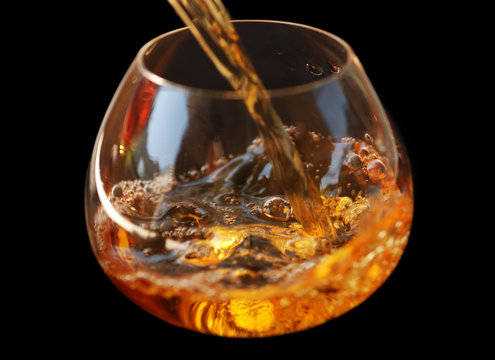 pouring whisky in glass