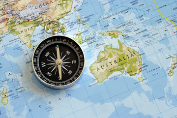 Fototapeta na wymiar magnetic compass and world map