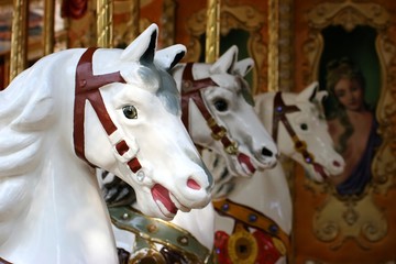 Fototapeta na wymiar three carousel horses