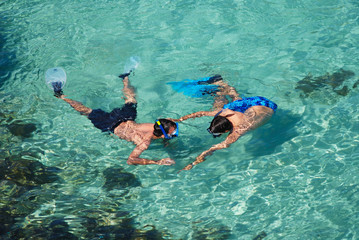two men snorkelling in majorcan cove