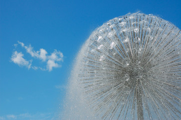 fountain of water on a background of the blue sky