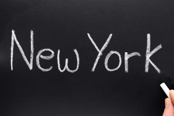 New York, written on a blackboard.