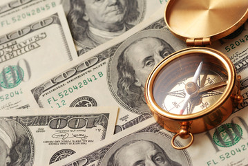 antique compass over money