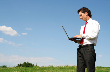 businessman using laptop outdoors