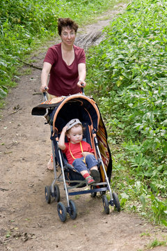 mum and child in a walking carriage