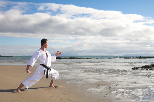 Man practicing Karate on the beach