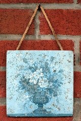 art tile closeup on a red brick wall