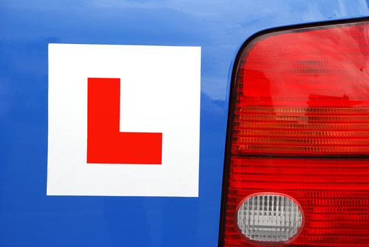 l plate on blue learner car - rear view